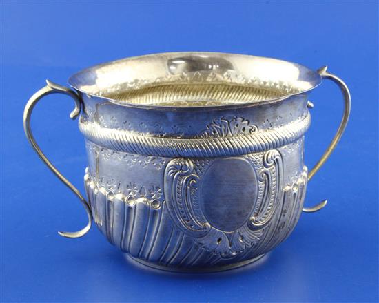 A Victorian repousse demi-spiral fluted silver porringer by Charles Stuart Harris, 7 oz.